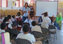Celeshia Guy teaching local kids about parrot conservation.